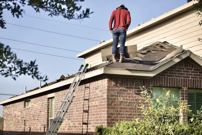 Professional roofer working on a residential roof in West Brandywine